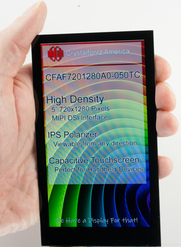 Display held in a hand. Display says "Crystalfontz America CFAF7201280A0-050TC High Density 5" 720x1280 Pixels MIPI DSI Interface IPS Polarizer Viewable from any direction Capacitive Touchscreen Perfect for handheld devices We have a display for that"