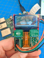 transparent oled displaying "hello world" with raspberry pi visible through the display