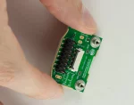 Carrier Board for 128x64 LCD Module, in hand to show size and perspective.