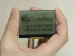 128x64 Low Power Transflective LCD Module, in hand to show size and perspective.