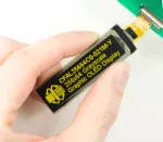 256x64 yellow, graphic OLED. In hand to show size and perspective.