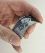 104x212 flexible ePaper display.in hand to show size and flexibility.