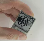 152x152 black and white ePaper display. In hand.