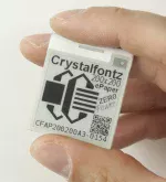 200x200 ePaper display, back view, in hand to show size and perspective.