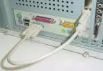 This shows the bracket end of the WR232Y09 in the
PC expansion slot (with the ribbon cable inside), and the WR232Y10 13 cable
connecting the WR232Y09 bracket end with the serial port.