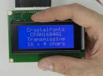 16x4 parallel character LCD with White characters on a blue background. Front view, in hand to show size and perspective. 16x4 parallel character LCD with White characters on a blue background. Front view, in hand to show size and perspective.