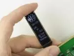 32x128 In-Cell Touchscreen OLED display, front view, in hand to show size and perspective.