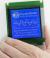 CFAG128128A1-TMI-TZ, white on blue graphic LCD,in hand to show size and perspective.