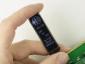 32x128 In-Cell Touchscreen OLED display, front view, in hand to show size and perspective.