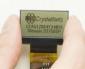 128x64 Transflective monochrome LCD module, front view in hand to show perspective. powered on.