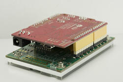 The CFA212-TMI is a complete development kit with an Seeeduino (Arduino Uno R3 clone), and a 128x64 CFAO12864D3-TMI graphic LCD display mounted on a CFA-10072 board – right perspective view of back.